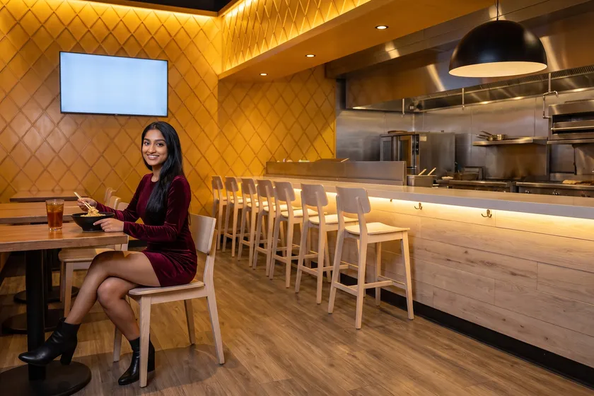 Woman with noodles at Chow Lucky Noodle Bar