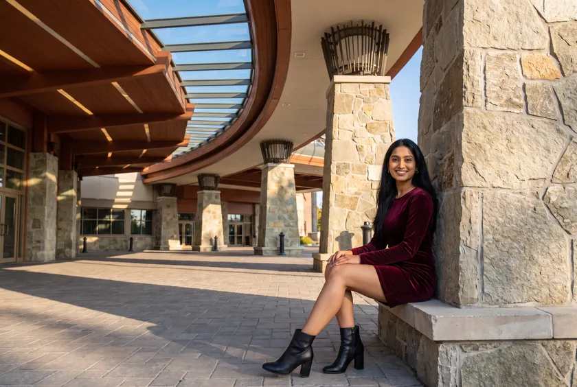 Woman under the stone-columned entrance canopy of Casino Rama
